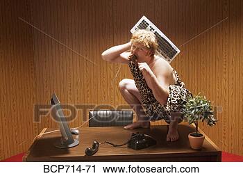 Stock Photography - businessman dressed 
as caveman crouching 
on desk. fotosearch 
- search stock 
photos, pictures, 
images, and photo 
clipart