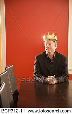 Stock Photography - businessman wearing 
gold crown in 
conference room. 
fotosearch - search 
stock photos, 
pictures, images, 
and photo clipart
