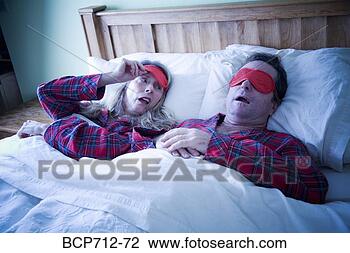 Stock Photo - woman peeking 
at man wearing 
eye mask. fotosearch 
- search stock 
photos, pictures, 
images, and photo 
clipart