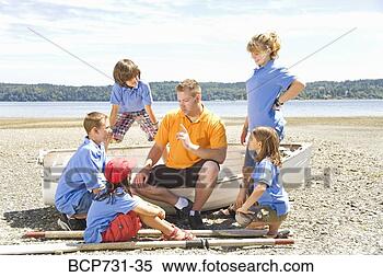 Stock Image - male camp counselor 
and children at 
beach. fotosearch 
- search stock 
photos, pictures, 
images, and photo 
clipart