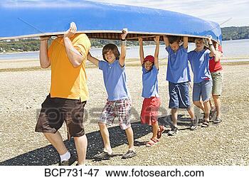 Picture - male camp counselor 
and children carrying 
canoe. fotosearch 
- search stock 
photos, pictures, 
images, and photo 
clipart