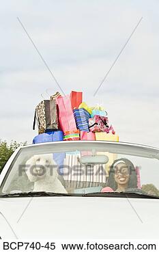 Stock Image - african woman 
in convertible 
with shopping 
bags. fotosearch 
- search stock 
photos, pictures, 
images, and photo 
clipart