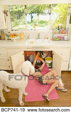 Stock Photograph - woman in bikini 
fixing plumbing 
under sink. fotosearch 
- search stock 
photos, pictures, 
images, and photo 
clipart