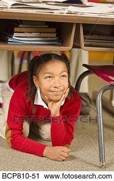 Stock Photography - african girl sitting 
under school desk. 
fotosearch - search 
stock photos, 
pictures, images, 
and photo clipart