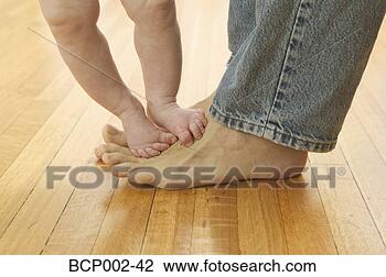 Stock Photo - closeup of a man 
in blue jeans 
with his baby's 
bare feet on his. 
fotosearch - search 
stock photos, 
pictures, images, 
and photo clipart