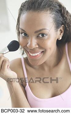 Stock Photo - a woman applying 
make-up to her 
face. fotosearch 
- search stock 
photos, pictures, 
images, and photo 
clipart