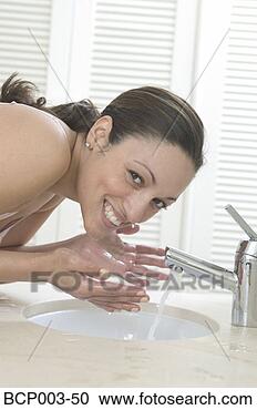 Stock Photography - woman bending 
over a sink to 
wash her face. 
fotosearch - search 
stock photos, 
pictures, images, 
and photo clipart