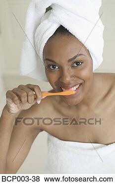 Stock Photo - a woman brushing 
her teeth. fotosearch 
- search stock 
photos, pictures, 
images, and photo 
clipart