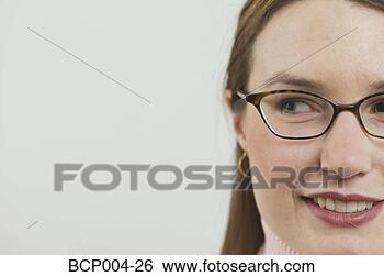 Stock Photo - cropped portrait 
of a young woman 
wearing glasses. 
fotosearch - search 
stock photos, 
pictures, images, 
and photo clipart