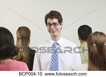 Stock Photography - a young, tall 
businessman surrounded 
by four colleagues. 
fotosearch - search 
stock photos, 
pictures, images, 
and photo clipart