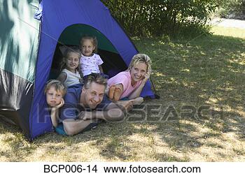 Stock Photo - caucasian family 
looking out of 
tent at campsite. 
fotosearch - search 
stock photos, 
pictures, images, 
and photo clipart