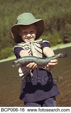 Stock Photo - young boy holding 
the fish he caught. 
fotosearch - search 
stock photos, 
pictures, images, 
and photo clipart