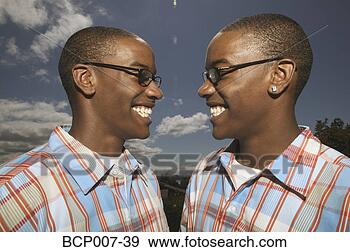 Stock Photograph - outdoors portrait 
of twin african-american 
teenage boys in 
glasses. fotosearch 
- search stock 
photos, pictures, 
images, and photo 
clipart