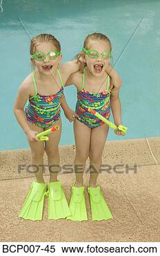 Stock Image - twin girls standing 
poolside. fotosearch 
- search stock 
photos, pictures, 
images, and photo 
clipart
