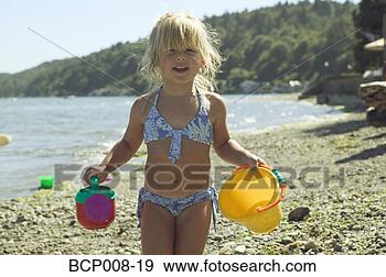 Stock Photograph - young girl holding 
beach toys. fotosearch 
- search stock 
photos, pictures, 
images, and photo 
clipart