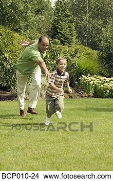Stock Photo - grandfather playing 
with his young 
grandson at the 
park. fotosearch 
- search stock 
photos, pictures, 
images, and photo 
clipart