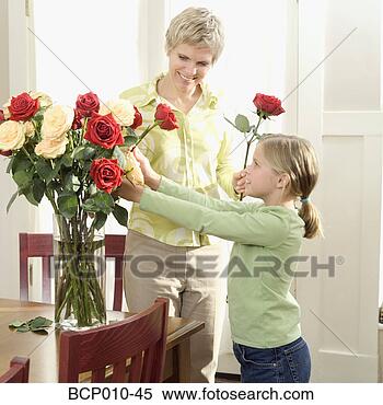 Stock Image - mother arranging 
roses with her 
daughter. fotosearch 
- search stock 
photos, pictures, 
images, and photo 
clipart