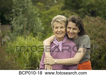 Stock Photo - a mother being 
embraced by her 
adult daughter. 
fotosearch - search 
stock photos, 
pictures, images, 
and photo clipart