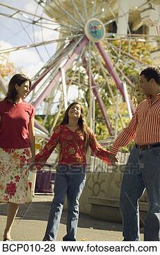 Stock Photo - parents and daughter 
at an amusement 
park. fotosearch 
- search stock 
photos, pictures, 
images, and photo 
clipart