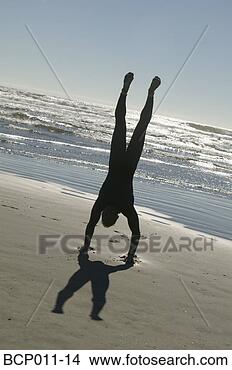 Stock Photo - man doing a handstand 
on the beach. 
fotosearch - search 
stock photos, 
pictures, images, 
and photo clipart