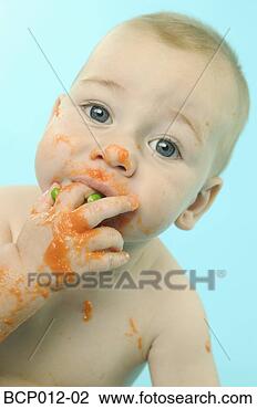 Stock Photo - infant eating 
baby food with 
fingers. fotosearch 
- search stock 
photos, pictures, 
images, and photo 
clipart