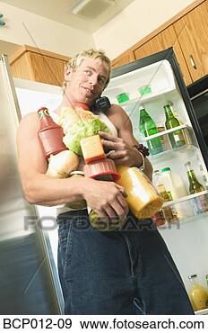 Stock Photograph - man talking on 
phone with his 
arms full of food. 
fotosearch - search 
stock photos, 
pictures, images, 
and photo clipart