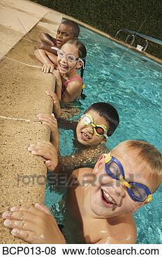 Stock Photo - four young swimmers 
on the edge of 
a pool. fotosearch 
- search stock 
photos, pictures, 
images, and photo 
clipart