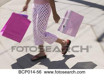 Stock Photo - a woman in polka 
dot pants carrying 
shopping bags. 
fotosearch - search 
stock photos, 
pictures, images, 
and photo clipart
