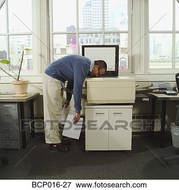 Picture - a man with his 
head in a copy 
machine. fotosearch 
- search stock 
photos, pictures, 
images, and photo 
clipart