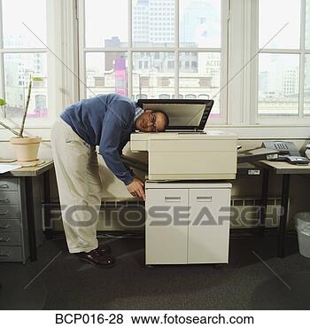 Stock Photo - a man with his 
head in a copy 
machine. fotosearch 
- search stock 
photos, pictures, 
images, and photo 
clipart