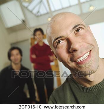 Stock Photography - man with two colleagues 
in the background. 
fotosearch - search 
stock photos, 
pictures, images, 
and photo clipart