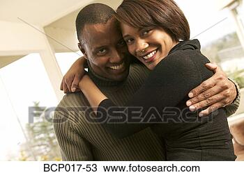 Stock Photo - a couple smiling 
and hugging. fotosearch 
- search stock 
photos, pictures, 
images, and photo 
clipart