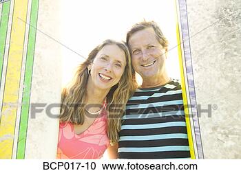 Stock Photography - a couple standing 
between surfboards. 
fotosearch - search 
stock photos, 
pictures, images, 
and photo clipart