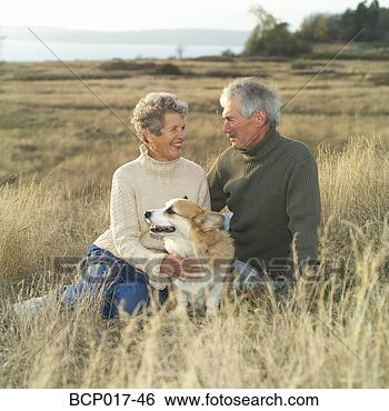 Stock Photo - a senior couple 
relaxing outside 
with their dog. 
fotosearch - search 
stock photos, 
pictures, images, 
and photo clipart