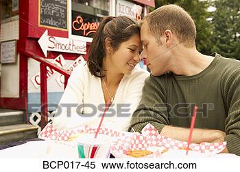 Stock Image - young couple share 
an intimate moment 
outdoors. fotosearch 
- search stock 
photos, pictures, 
images, and photo 
clipart