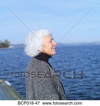 Picture - profile of a senior 
woman beside a 
lake. fotosearch 
- search stock 
photos, pictures, 
images, and photo 
clipart