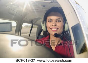 Picture - female pilot in 
the cockpit of 
an airplane. fotosearch 
- search stock 
photos, pictures, 
images, and photo 
clipart