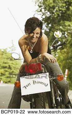 Stock Photo - woman on motorcycle 
with a 'just divorced' 
sign. fotosearch 
- search stock 
photos, pictures, 
wall murals, images, 
and photo clipart