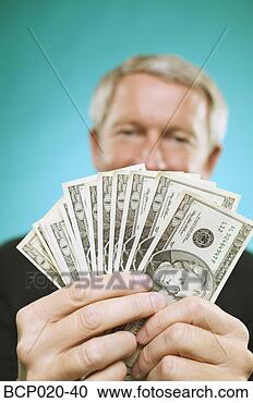 Stock Photography - man holding a 
fan of money. 
fotosearch - search 
stock photos, 
pictures, images, 
and photo clipart