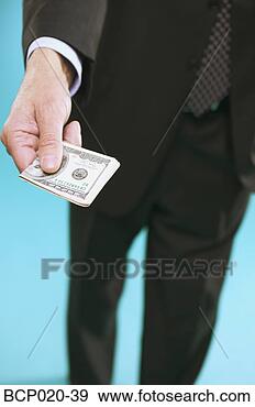 Stock Photograph - a man in a suit 
offering money. 
fotosearch - search 
stock photos, 
pictures, images, 
and photo clipart