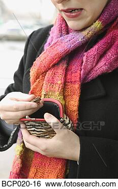 Stock Photo - a woman counts 
the change in 
her coin purse. 
fotosearch - search 
stock photos, 
pictures, images, 
and photo clipart