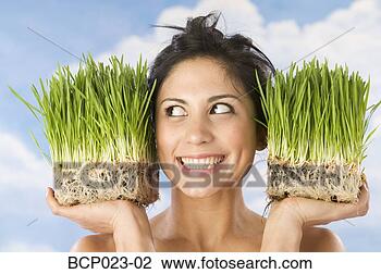 Stock Photo - woman holding 
pots of wheat 
grass. fotosearch 
- search stock 
photos, pictures, 
images, and photo 
clipart