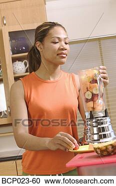Stock Photography - woman making a 
blended fruit 
drink. fotosearch 
- search stock 
photos, pictures, 
images, and photo 
clipart