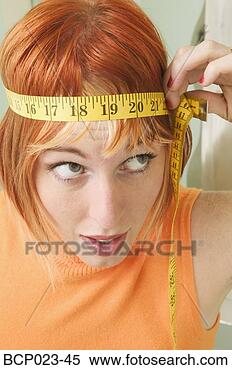 Stock Image - woman with measuring 
tape around her 
head. fotosearch 
- search stock 
photos, pictures, 
images, and photo 
clipart