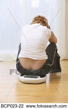 Stock Photo - a woman who is 
unhappy about 
her weight. fotosearch 
- search stock 
photos, pictures, 
images, and photo 
clipart
