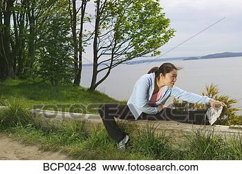 Stock Photo - a young woman 
stretching. fotosearch 
- search stock 
photos, pictures, 
images, and photo 
clipart