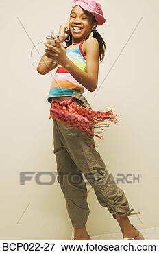 Picture - young girl listening 
to music. fotosearch 
- search stock 
photos, pictures, 
images, and photo 
clipart