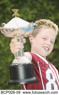 Stock Photograph - boy holding a 
trophy. fotosearch 
- search stock 
photos, pictures, 
images, and photo 
clipart