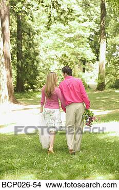 Stock Photo - newlywed couple 
walking through 
a park. fotosearch 
- search stock 
photos, pictures, 
images, and photo 
clipart