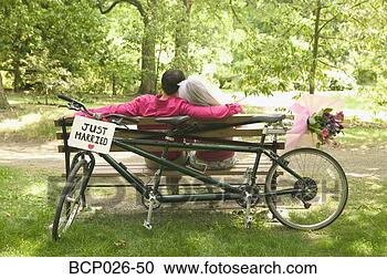 Stock Photography - newlyweds relax 
after a bicycle 
ride. fotosearch 
- search stock 
photos, pictures, 
images, and photo 
clipart